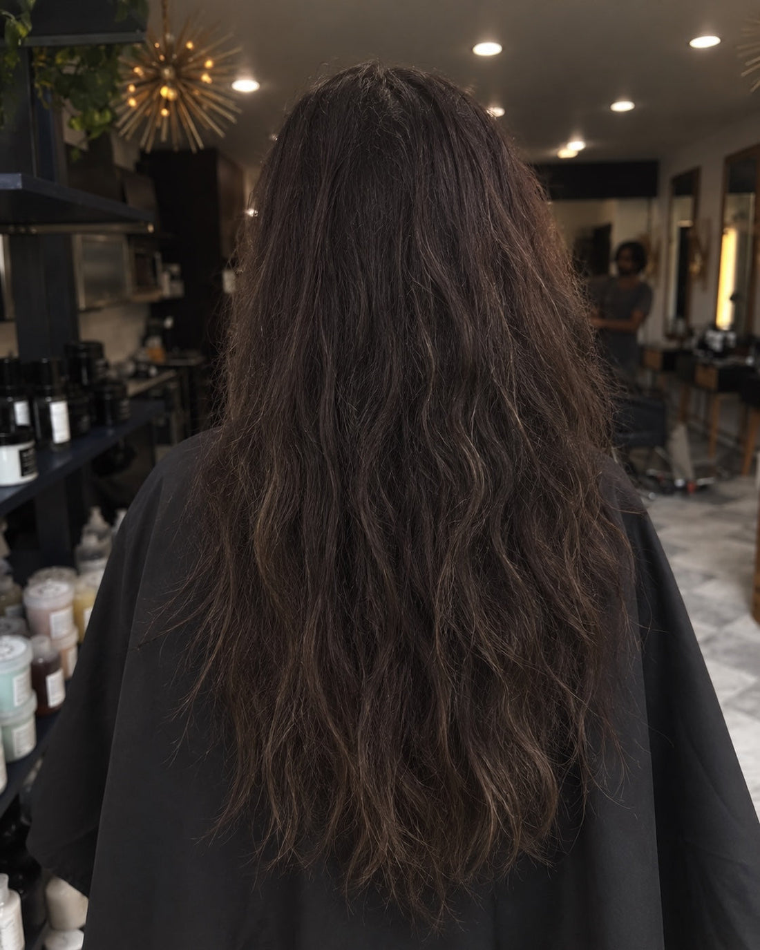 Long dark hair, styled but dry and needing a cut, before a trim at Mahne Roots Collective, Broomfield